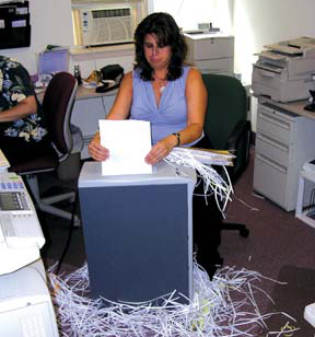 same_woman_shredding_with_a_manual_shredder_for_the_doucment_destruction_article_that_has_the_other_picture_on_it